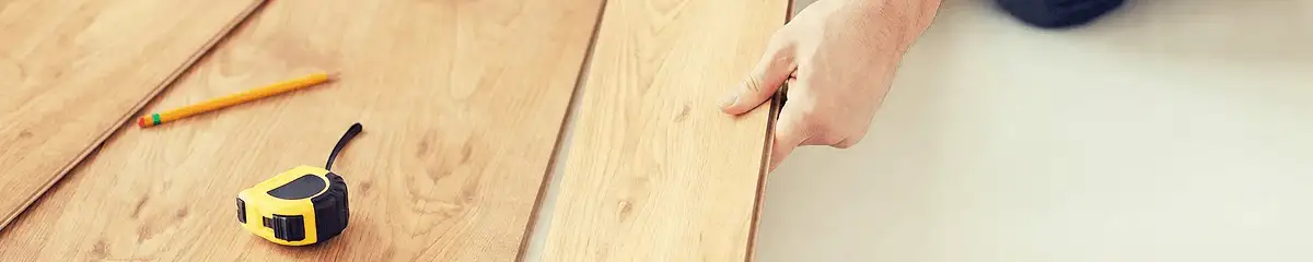 A professional installing wood flooring in Boise, ID