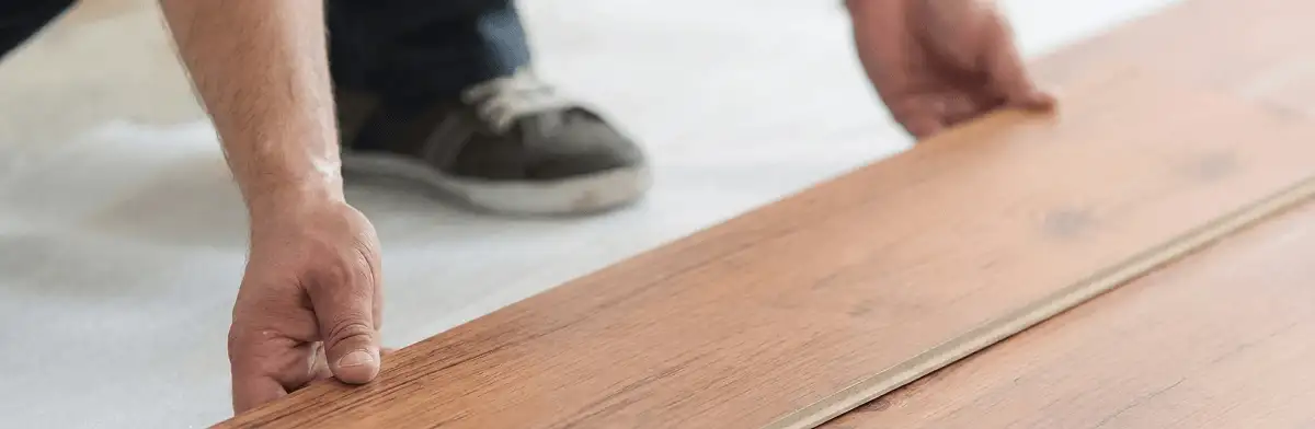 A professional installing laminate flooring in Boise, ID